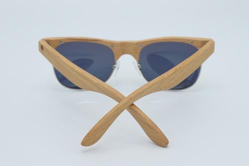 Lumiere Sunglasses featuring a natural Beech wood frame and yellow tinted UV400 polarized lenses, elegantly displayed in a wooden box.