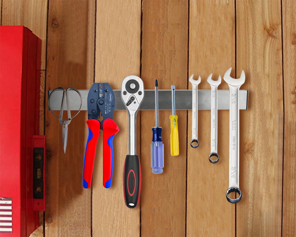 Heavy-duty magnetic wall mount knife holder in silver, securely holding various kitchen knives and utensils.