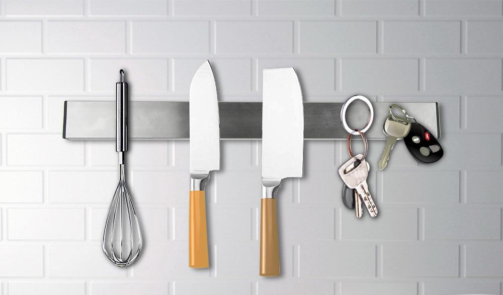 Heavy-duty magnetic wall mount knife holder in silver, securely holding various kitchen knives and utensils.