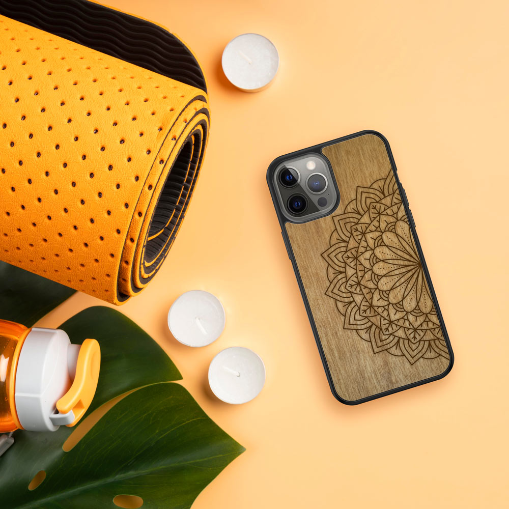 Engraved Mandala wooden phone case on Tanganika wood, showcasing intricate design and natural wood grain.