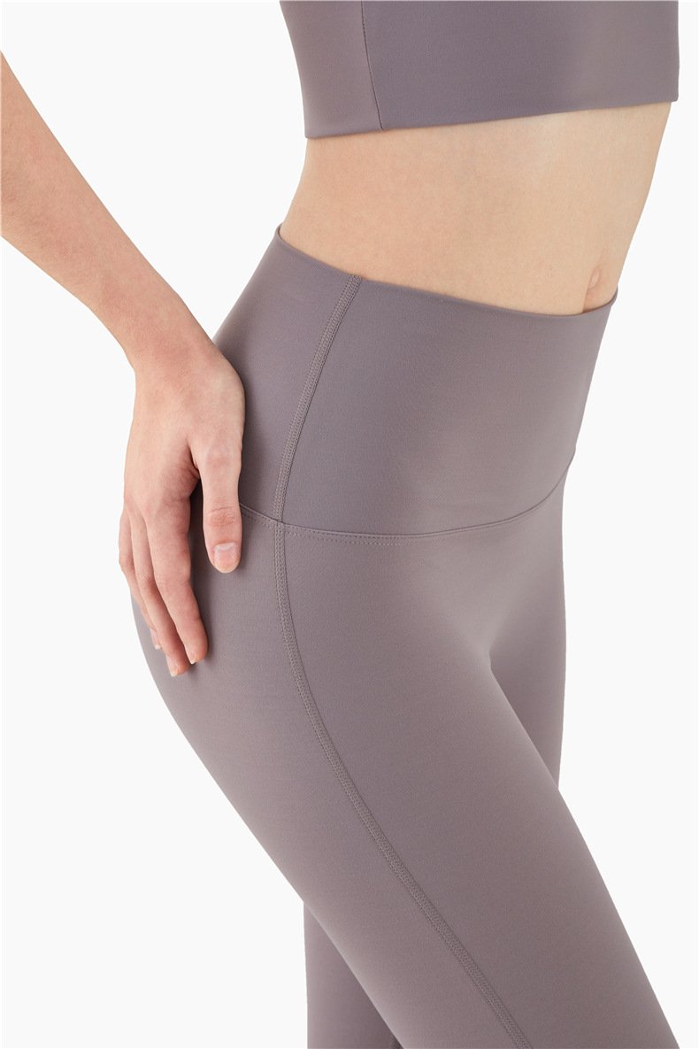 Women wearing mid compression second-skin feel gym tights, showcasing their flexibility and comfort during a workout.