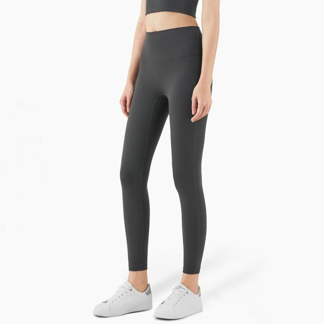 Women wearing mid compression second-skin feel gym tights, showcasing their flexibility and comfort during a workout.