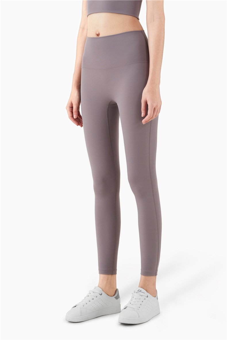 Women wearing mid compression second-skin feel gym tights, showcasing their flexibility and comfort during a workout.