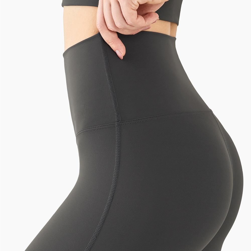 Women wearing mid compression second-skin feel gym tights, showcasing their flexibility and comfort during a workout.