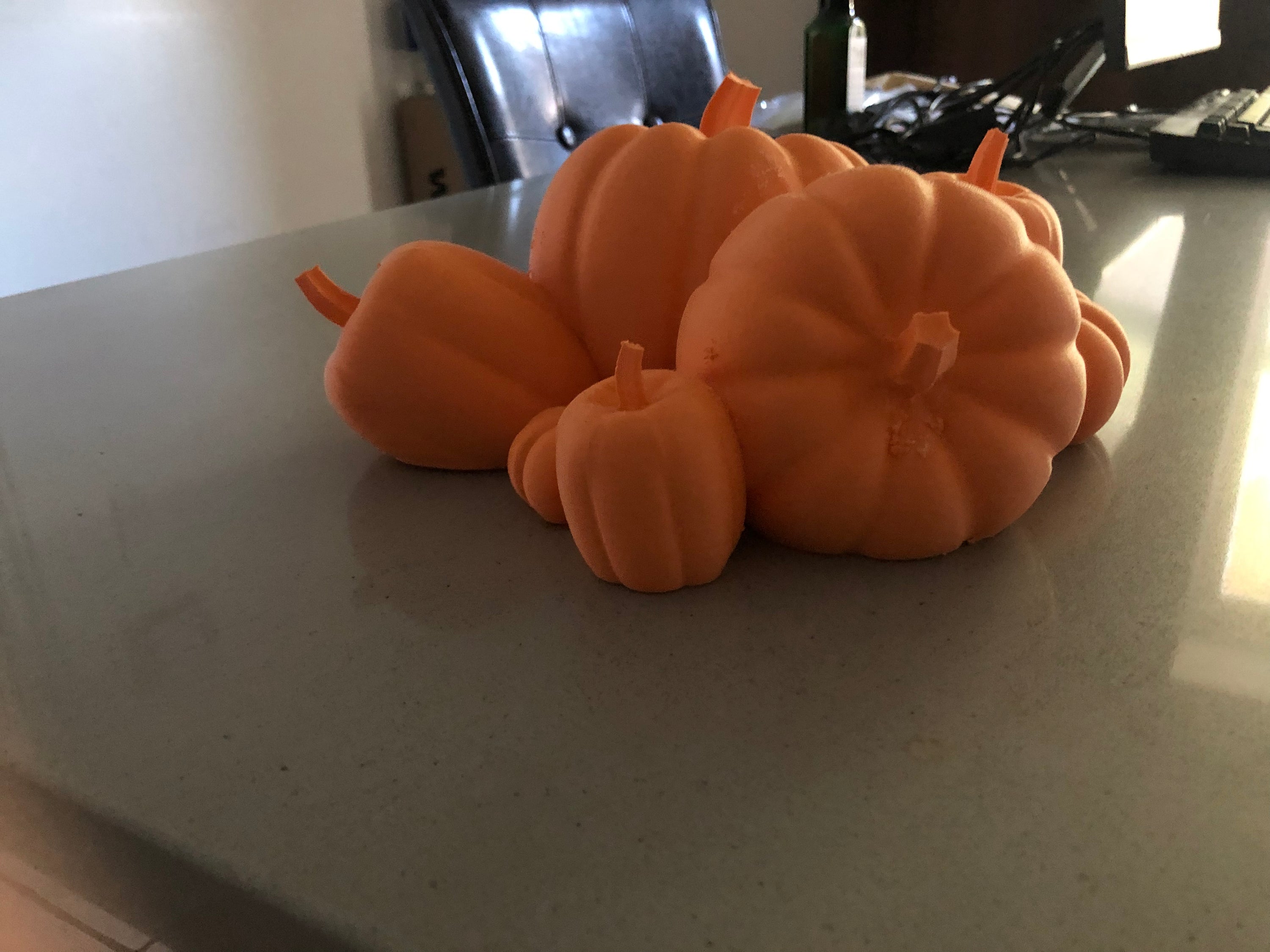 A vibrant Mini Pumpkin Patch featuring bright orange pumpkins, perfect for indoor or outdoor decoration, measuring 4.33 inches tall and 10.23 inches wide.