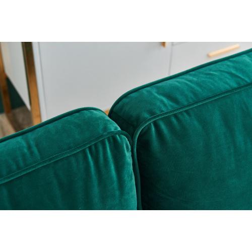 Modern Velvet fabric sofa in emerald green with golden metal legs and decorative pillows.