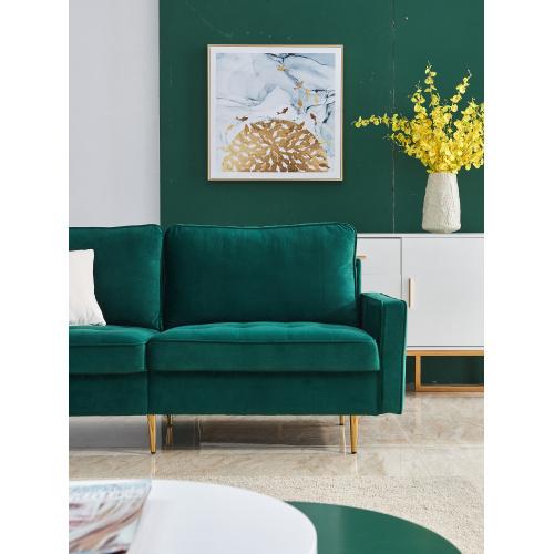 Modern Velvet fabric sofa in emerald green with golden metal legs and decorative pillows.