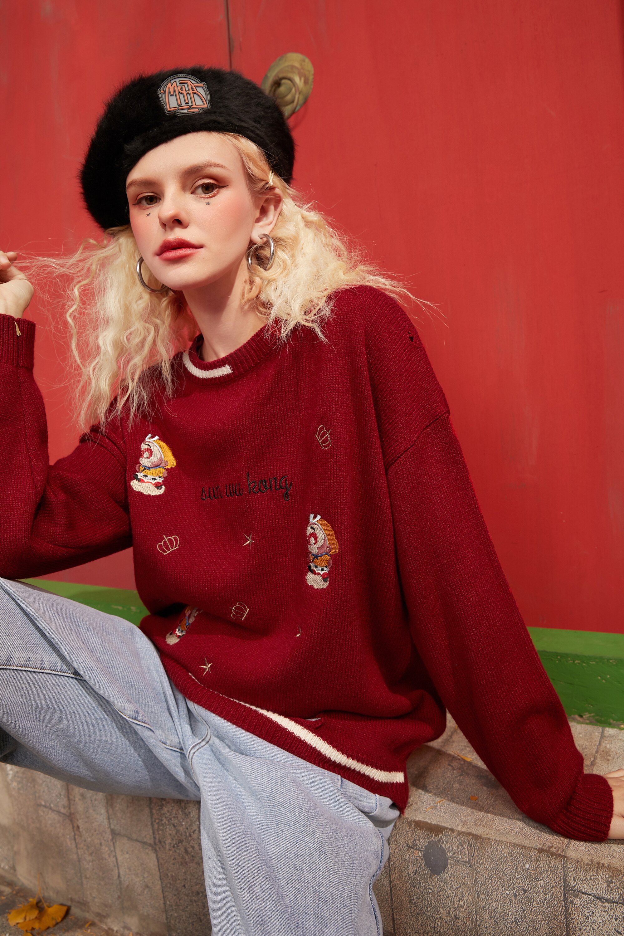 A vibrant red and green Monkey King Embroidery Casual Knit Pullover Sweater for women, featuring a drop shoulder design and playful cartoon pattern.