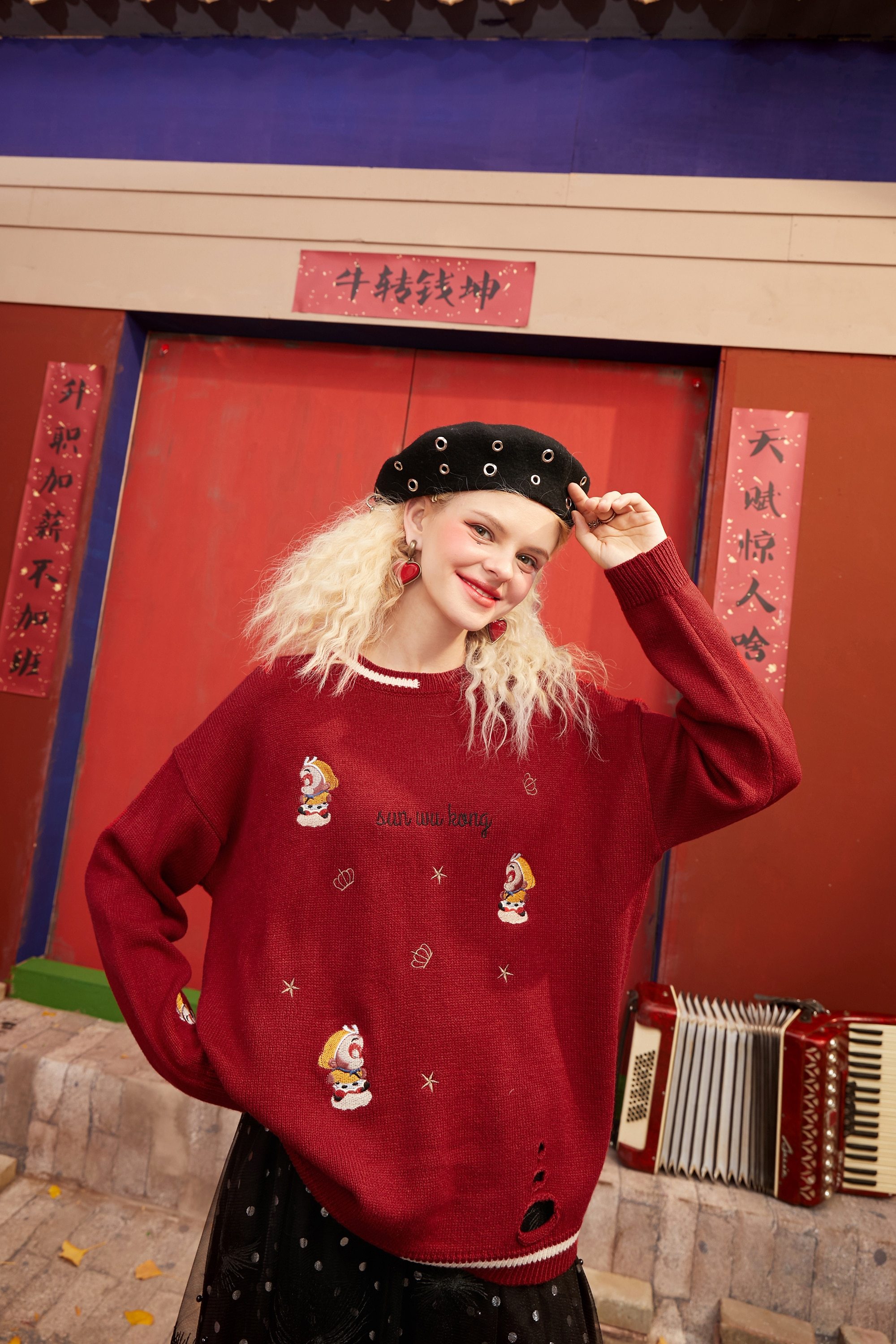 A vibrant red and green Monkey King Embroidery Casual Knit Pullover Sweater for women, featuring a drop shoulder design and playful cartoon pattern.