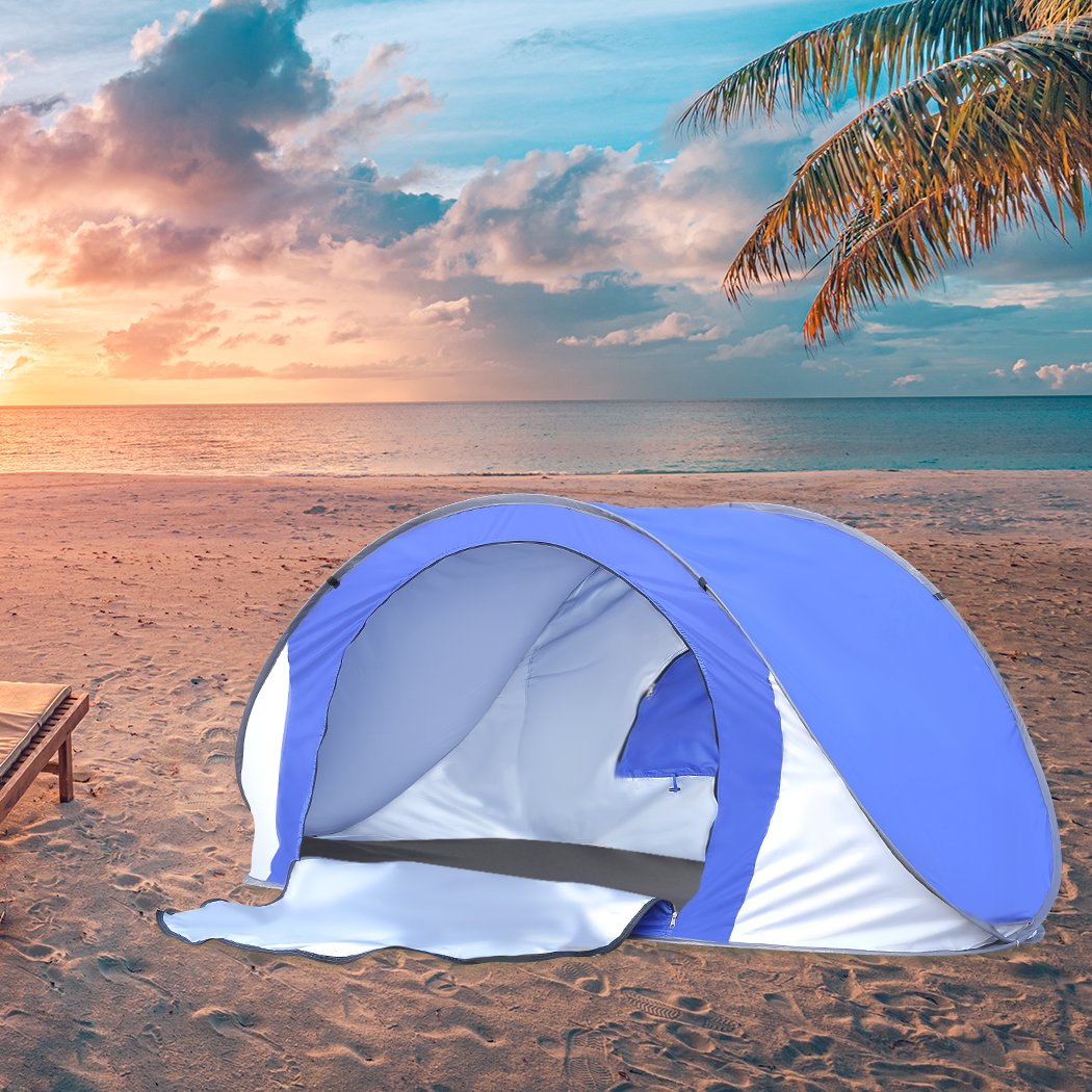 Mountview Pop Up Tent in blue color set up on the beach, showcasing its spacious interior and automatic opening feature.