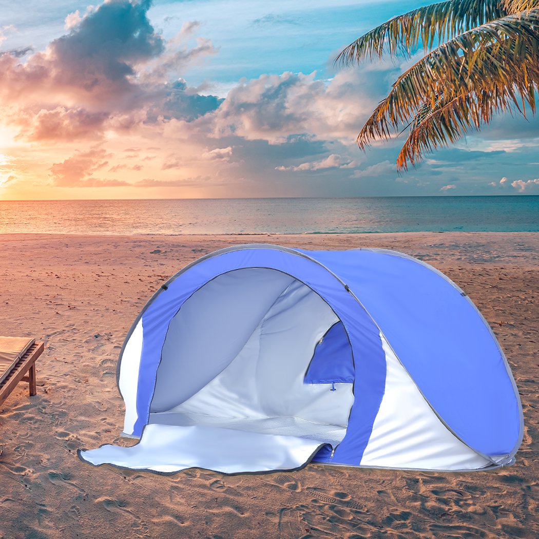 Mountview Pop Up Tent in blue color set up on the beach, showcasing its spacious interior and breathable mesh design.