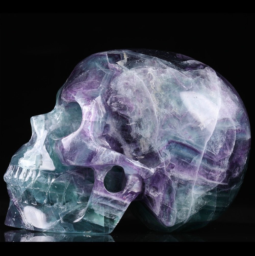 Natural Purple Fluorite 5 Inch Gemstone Skull showcasing vibrant colors and intricate details, symbolizing creativity and emotional healing.