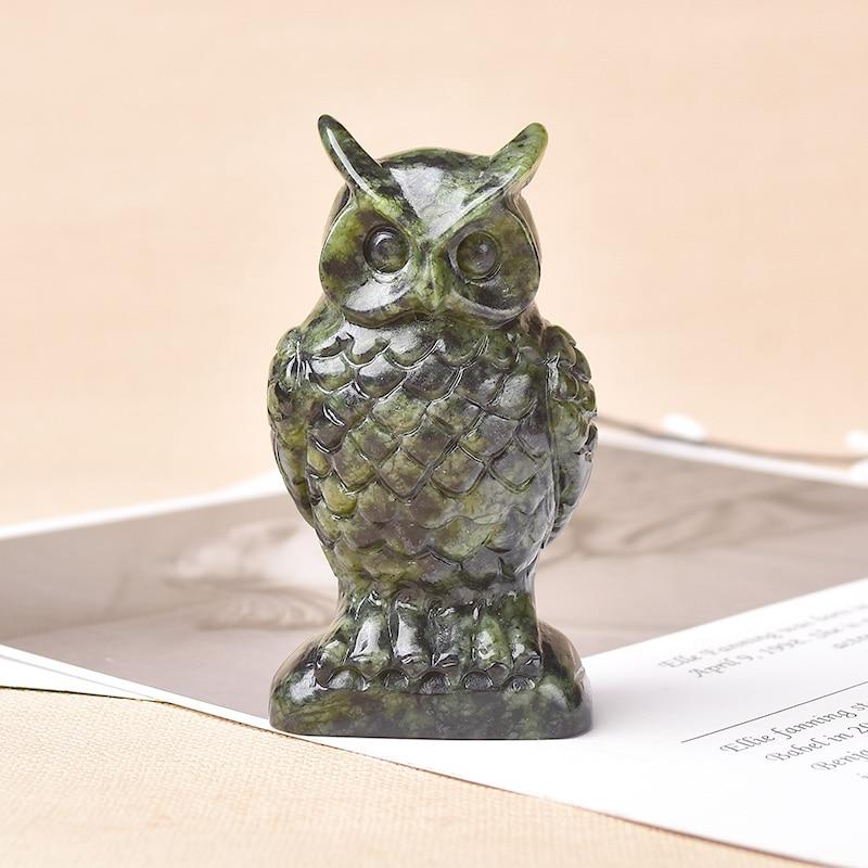 A beautifully handcrafted Natural Stone Carved Owl Figurine made from genuine crystals, showcasing intricate details and a vibrant sheen.