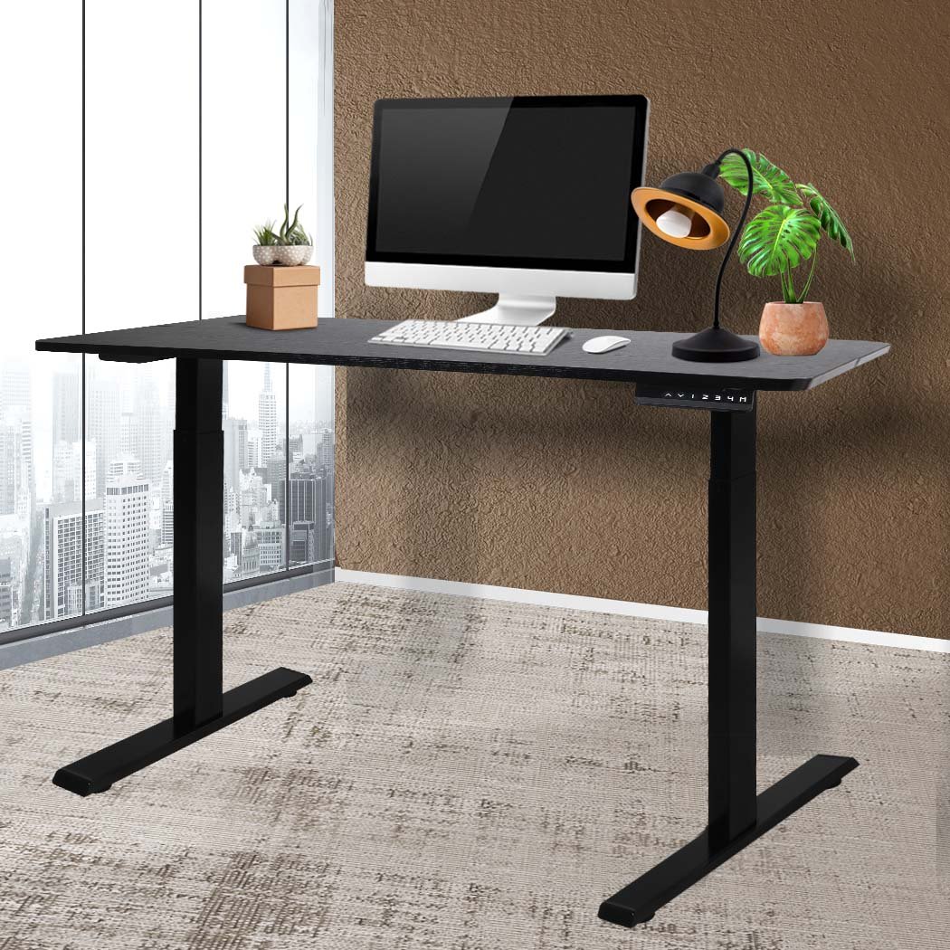 A sleek black motorised electric desk with height adjustment features, showcasing a modern design suitable for any office space.