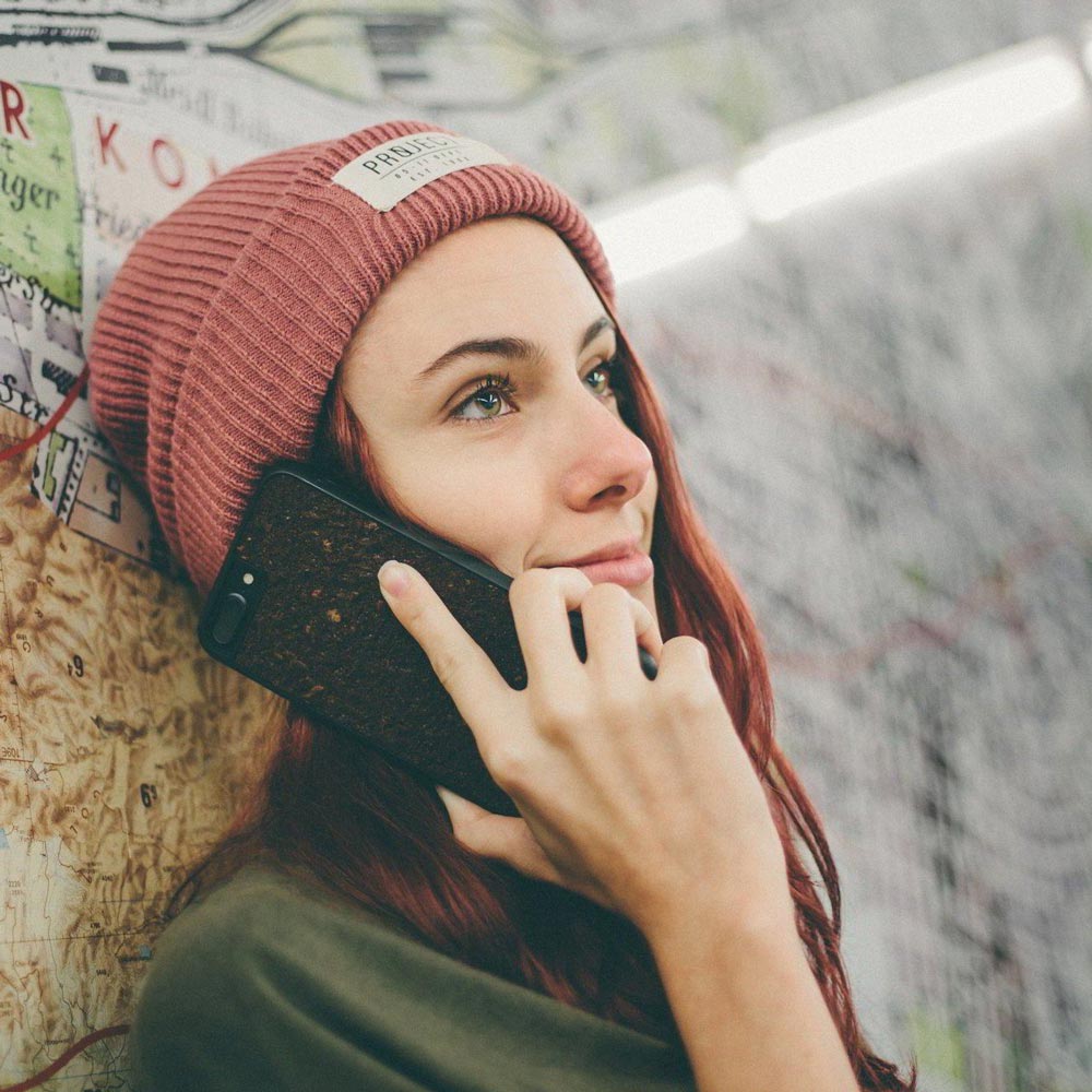 Organic Coffee Phone Case featuring a unique texture and aroma, held by a woman, showcasing its eco-friendly design.