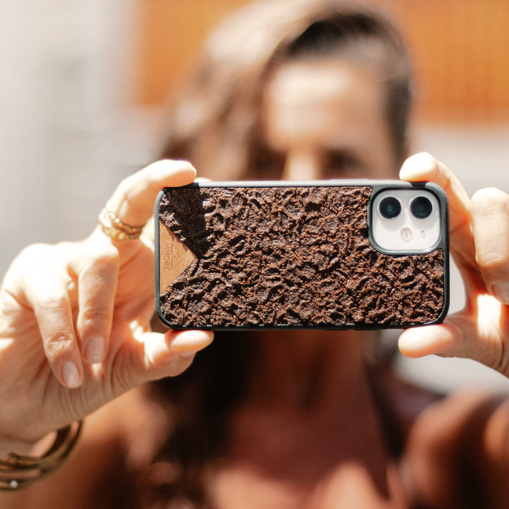 Organic Coffee Phone Case featuring a unique texture and aroma, held by a woman, showcasing its eco-friendly design.