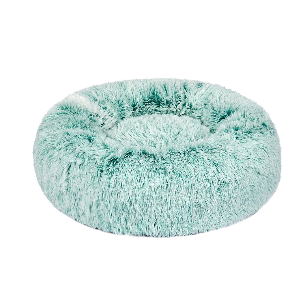 Teal donut-shaped pet bed with plush surface and raised rim, designed for dogs and cats to provide comfort and security.