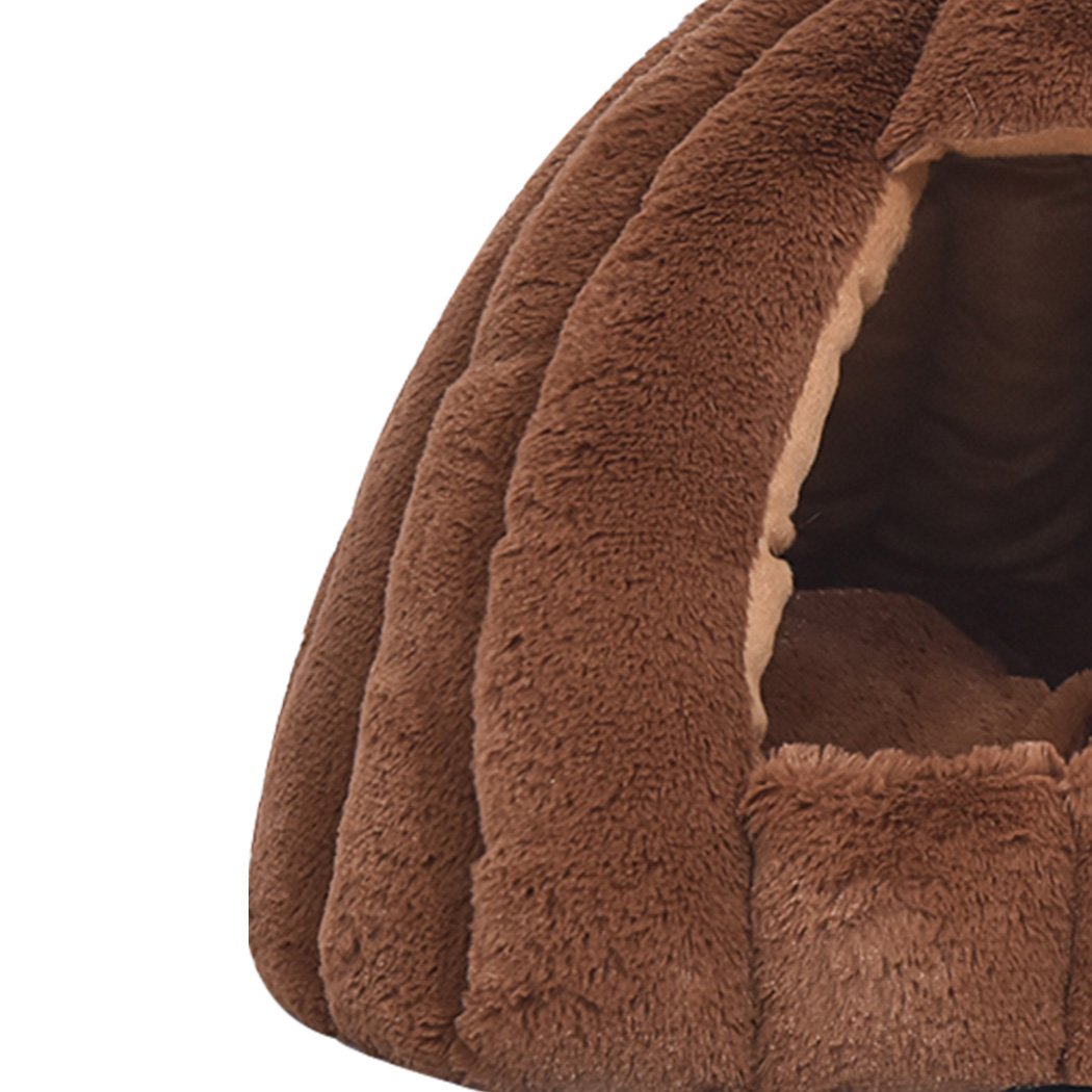 Brown Comfy Kennel Cave Pet Bed designed for cats and dogs, featuring a pumpkin house design and soft flannel material for warmth.