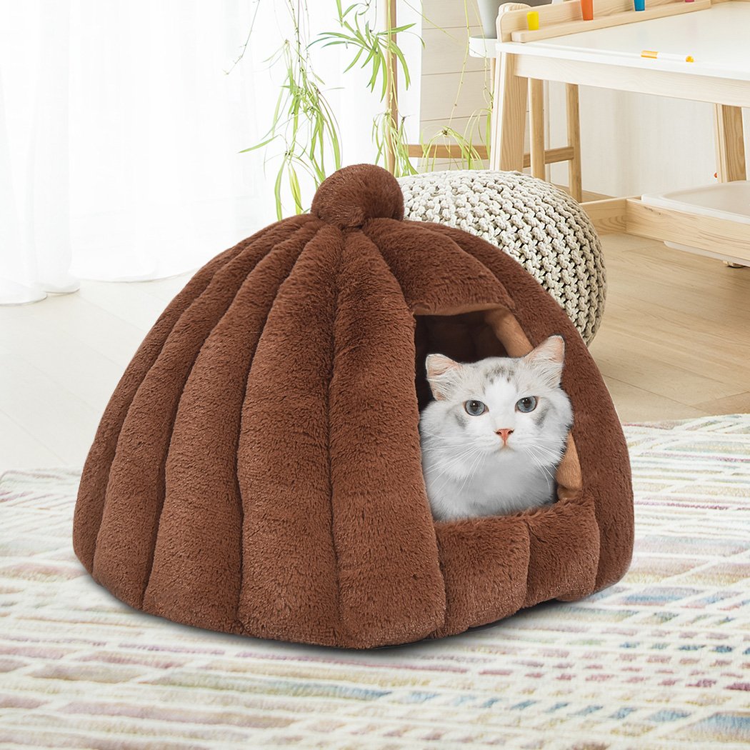 Brown Comfy Kennel Cave Pet Bed designed for cats and dogs, featuring a pumpkin house design and soft flannel material for warmth.