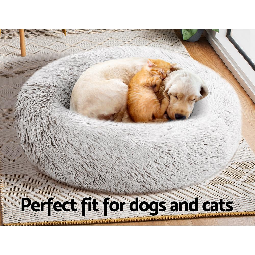 Medium-sized white pet bed with brown accents, designed for dogs and cats, featuring a soft surface and non-slip base.