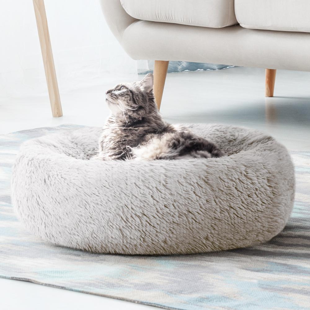 Medium-sized white pet bed with brown accents, designed for dogs and cats, featuring a soft surface and non-slip base.