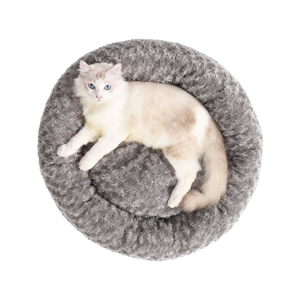 Soft plush pet bed in a calming donut shape, perfect for dogs and cats, featuring a grey color and anti-slip bottom for stability.