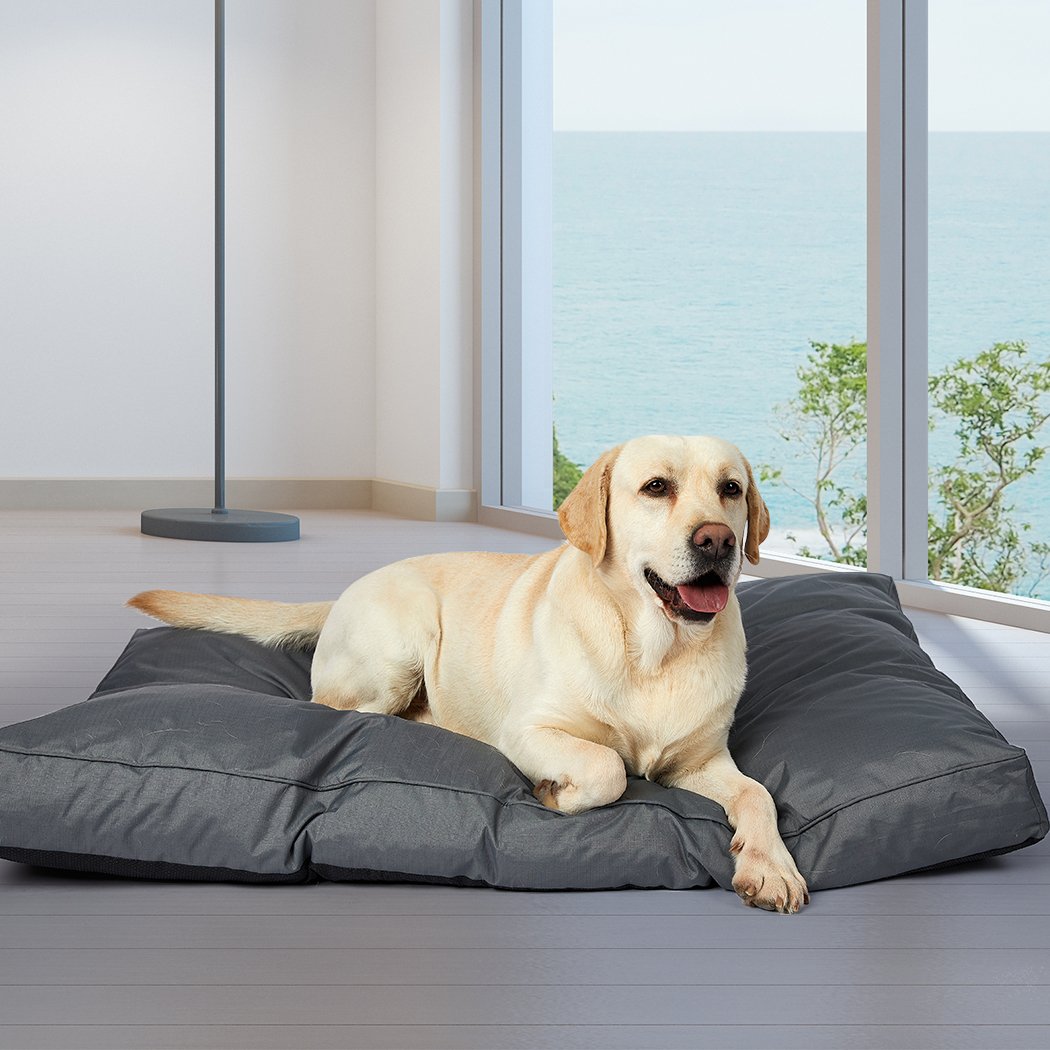 A cozy grey pet bed made of soft fleece and durable oxford fabric, designed for dogs and cats with a plush, overstuffed cushion for ultimate comfort.