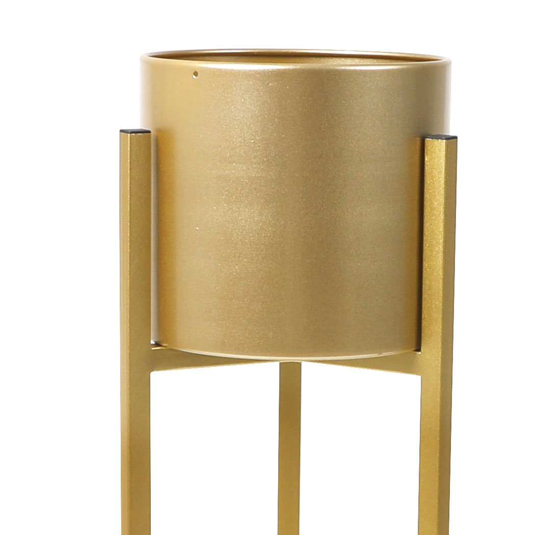 Elegant metal plant stand with a gold finish, showcasing a beautiful flower pot, perfect for home and garden decor.