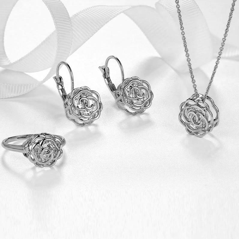 Rose Is A Rose jewelry set featuring a ring, earrings, and pendant in 18kt gold with diamond crystal accents, elegantly displayed.