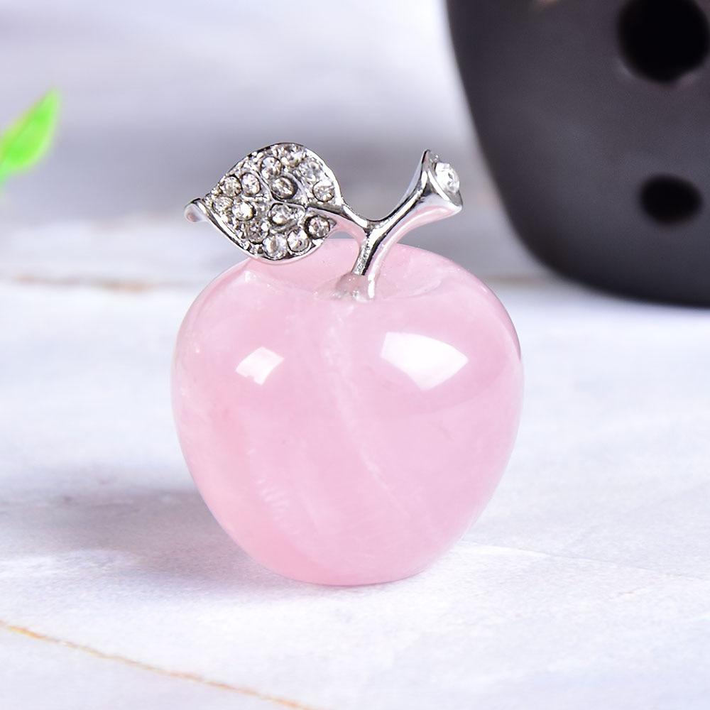 A beautiful rose quartz crystal apple, approximately 22x20mm in size, showcasing its delicate pink hue and smooth surface.