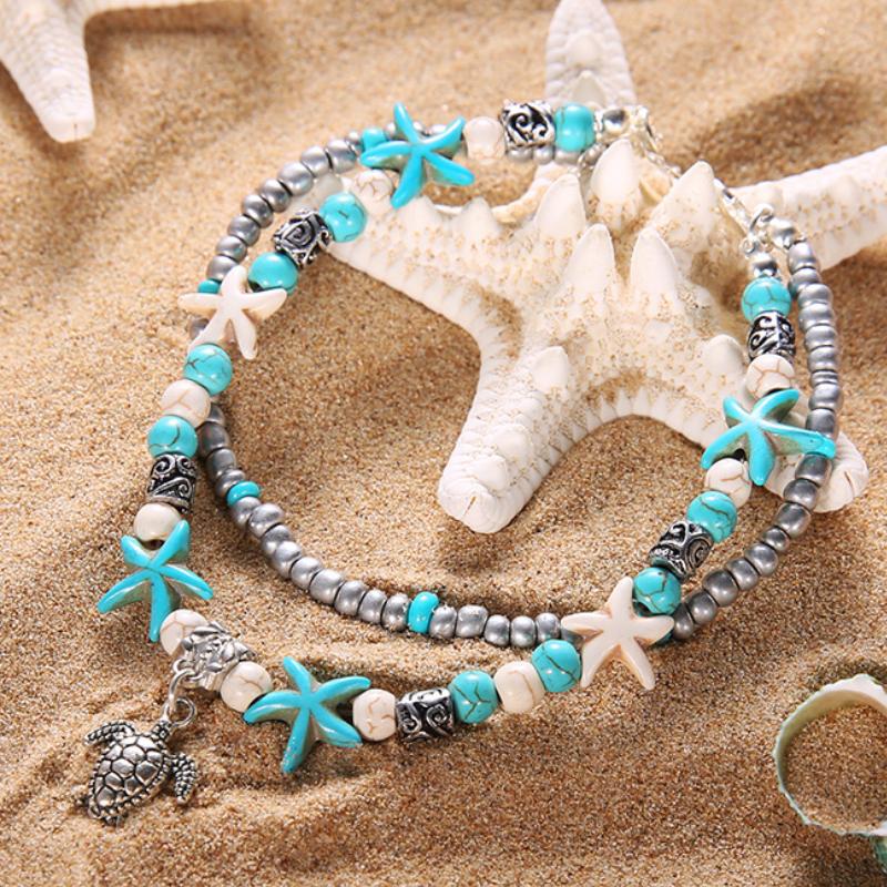 A beautiful Sea Turtle Anklet featuring turquoise and white Hematite beads with a white gold-plated chain and Sea Turtle charm.