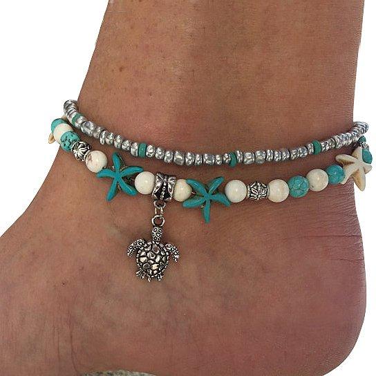 A beautiful Sea Turtle Anklet featuring turquoise and white Hematite beads with a white gold-plated chain and Sea Turtle charm.