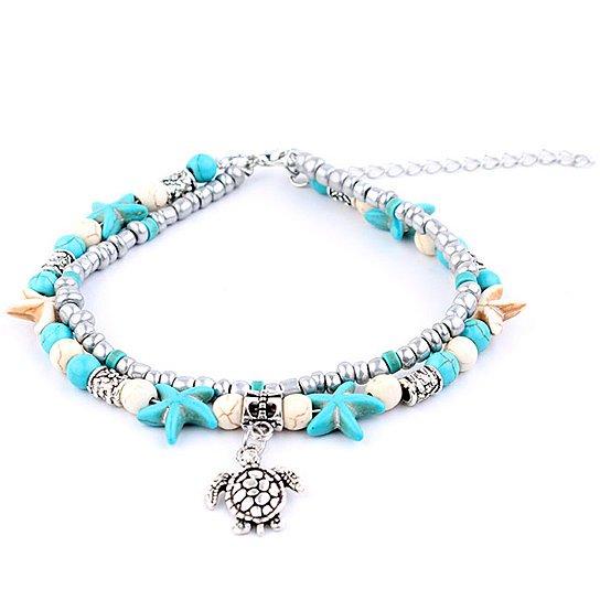 A beautiful Sea Turtle Anklet featuring turquoise and white Hematite beads with a white gold-plated chain and Sea Turtle charm.