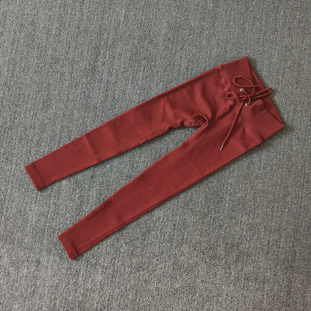 A pair of seamless solid color yoga pants for women, showcasing a high waist design and available in various colors.