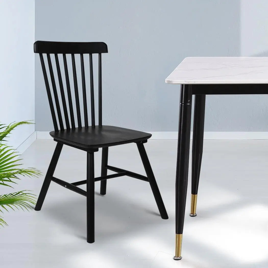 Set of 2 black dining chairs made of solid wood, showcasing a sleek and modern design suitable for various dining spaces.