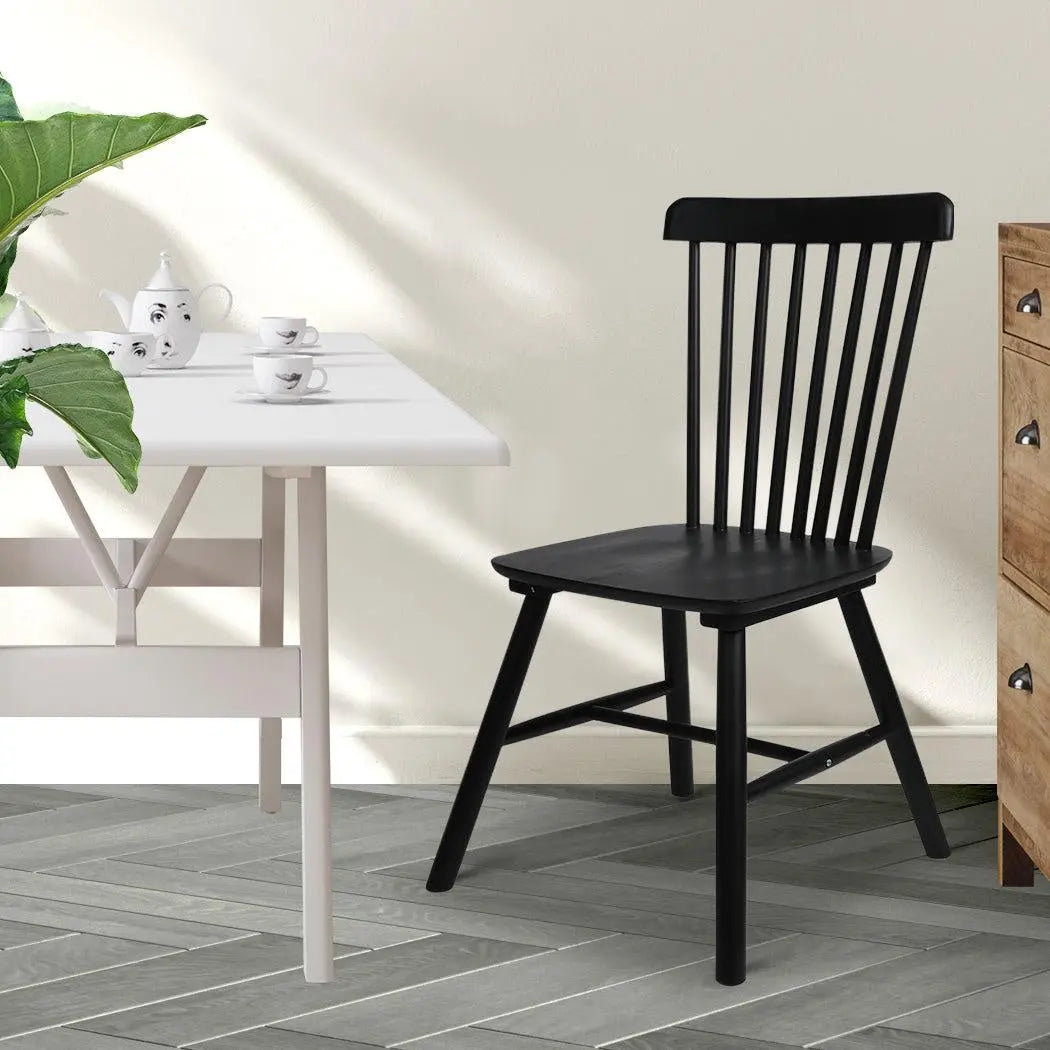 Set of 2 black dining chairs made of solid wood, showcasing a sleek and modern design suitable for various dining spaces.