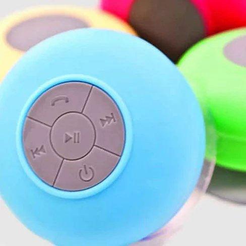 A vibrant Bluetooth speaker designed for use in the shower, featuring a waterproof silicone exterior and built-in microphone for hands-free calls.