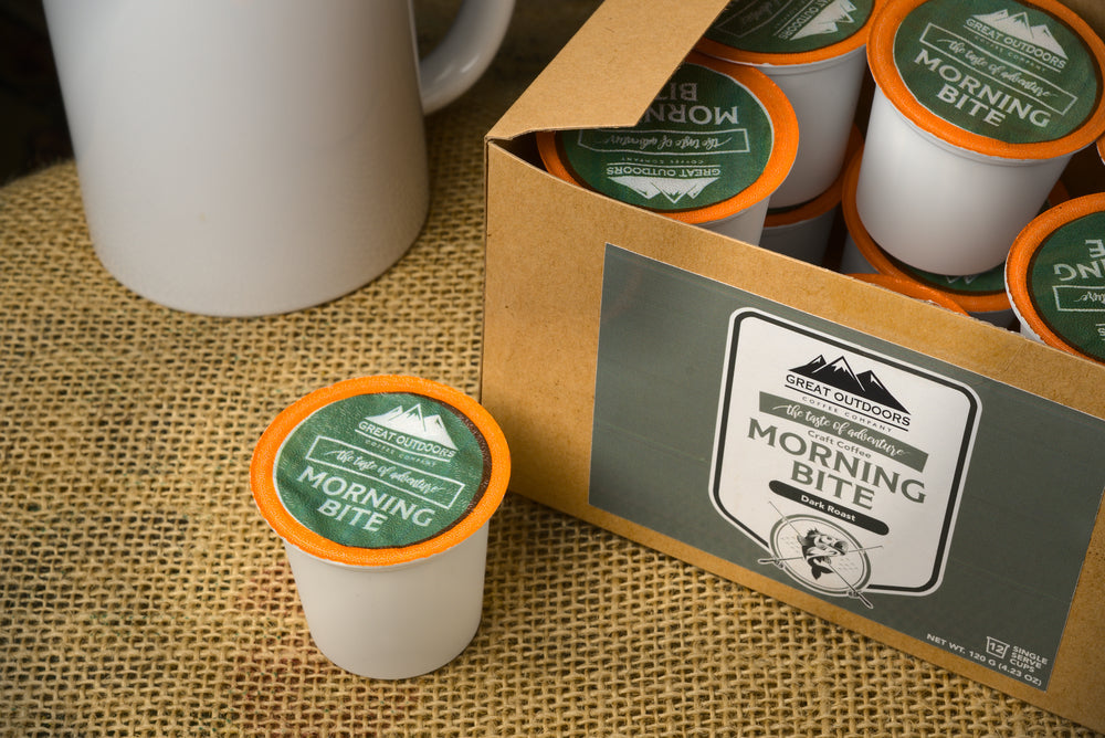 A collection of 48 single serve coffee pods in various flavors, neatly arranged in a box, showcasing the Sunrise, Morning Bite, Double Barrel, and Campfire blends.