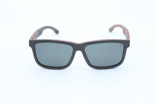 Stylish Skate Sunglasses made from skateboard wood with polarized lenses, displayed in a natural setting.