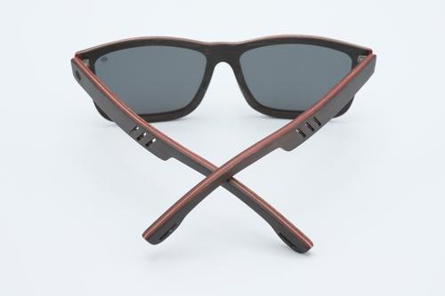 Stylish Skate Sunglasses made from skateboard wood with polarized lenses, displayed in a natural setting.