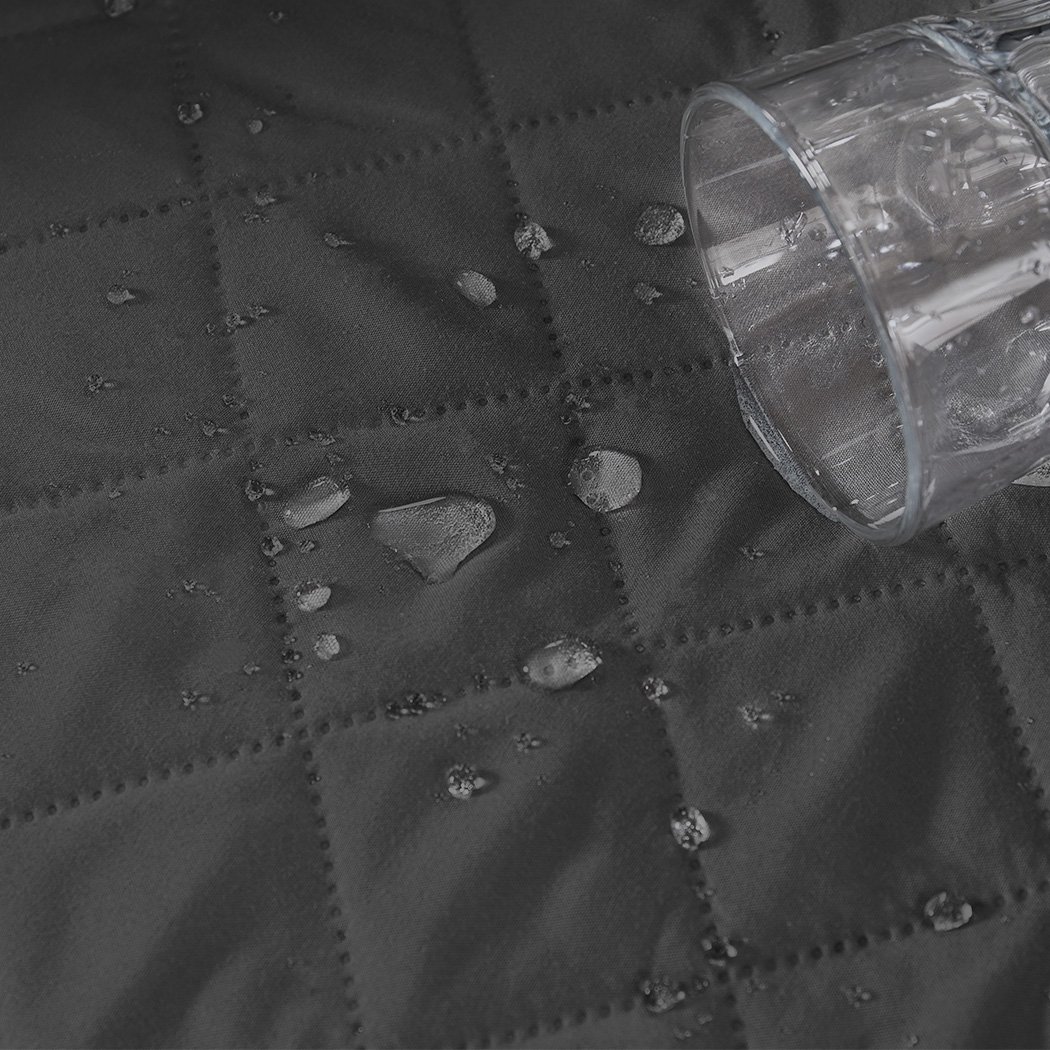 Grey quilted sofa cover protector, waterproof and stylish, designed for comfort and durability.