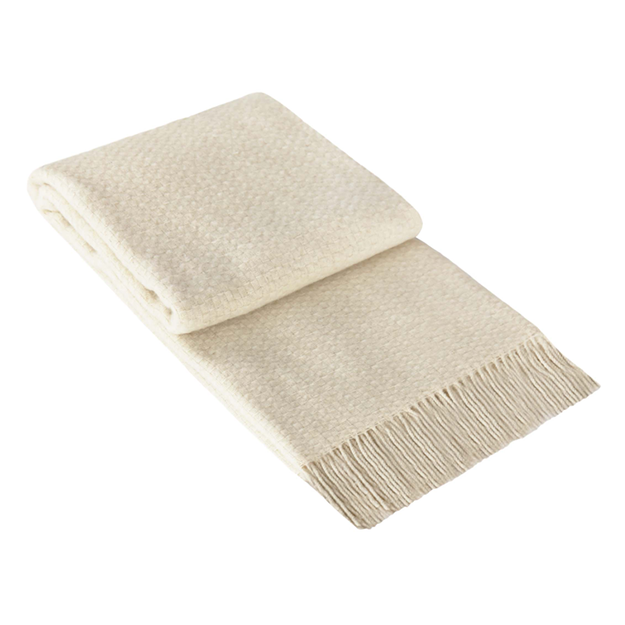 Soho Throw blanket in ivory, showcasing its soft wool blend texture and elegant design, perfect for enhancing living spaces.