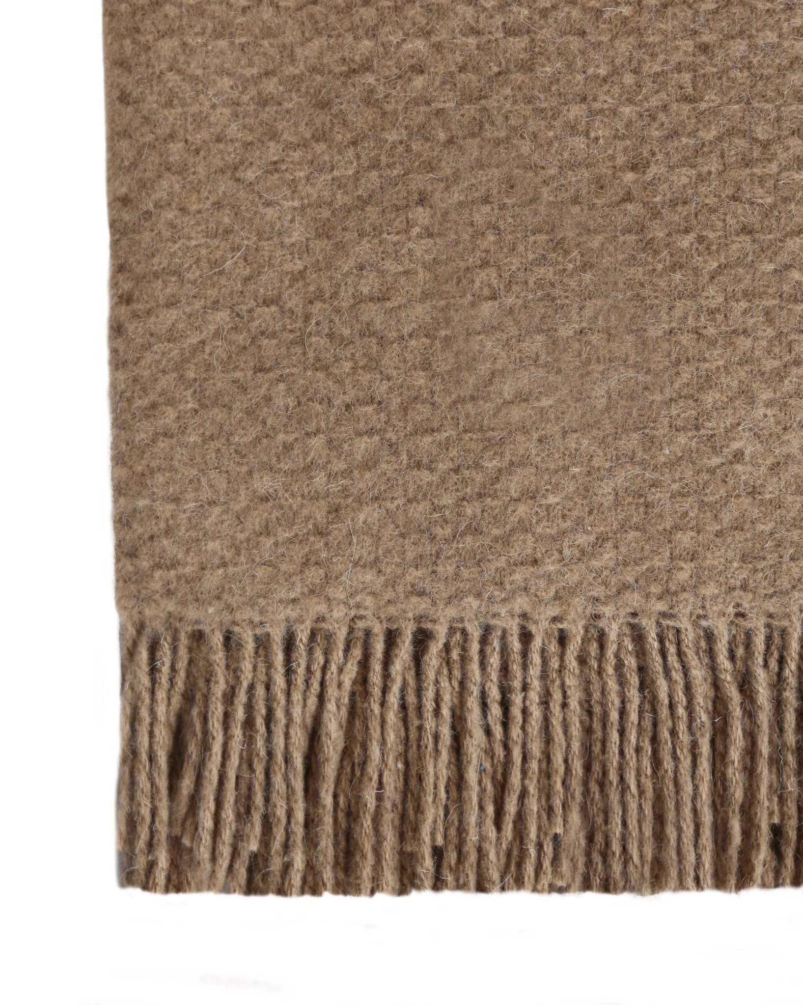 Soho Throw blanket in tan, showcasing a luxurious wool blend texture, perfect for cozying up in any living space.