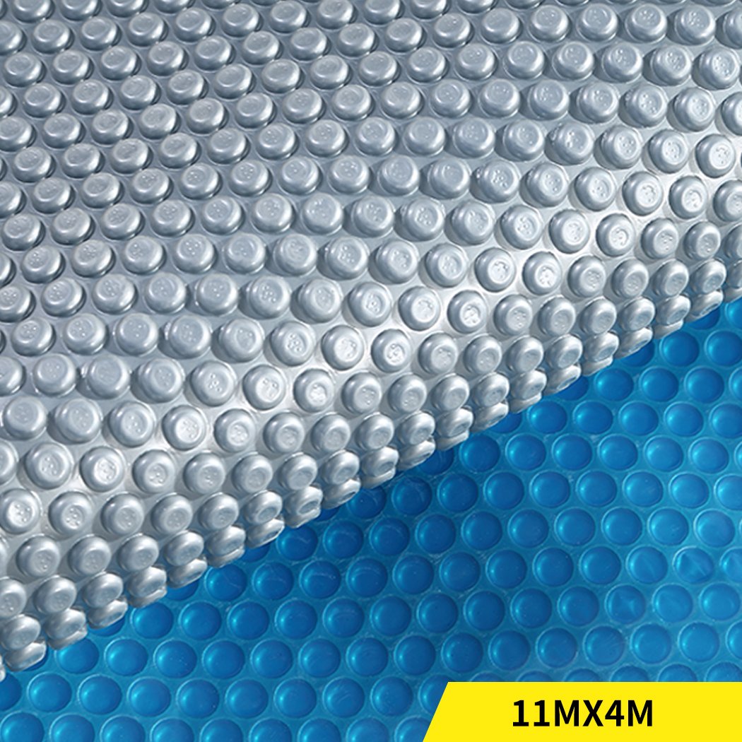 Solar Swimming Pool Cover with blue top and silver bottom, designed for warmth and cleanliness, featuring durable bubbles.