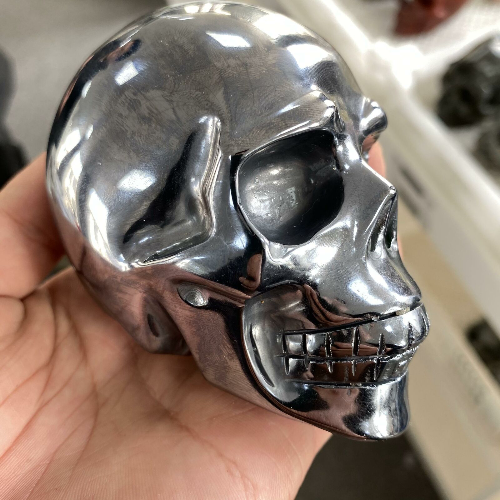 Hand-carved Solid Titanium Metal Skull showcasing intricate details and natural metallic finish, ideal for spiritual practices.