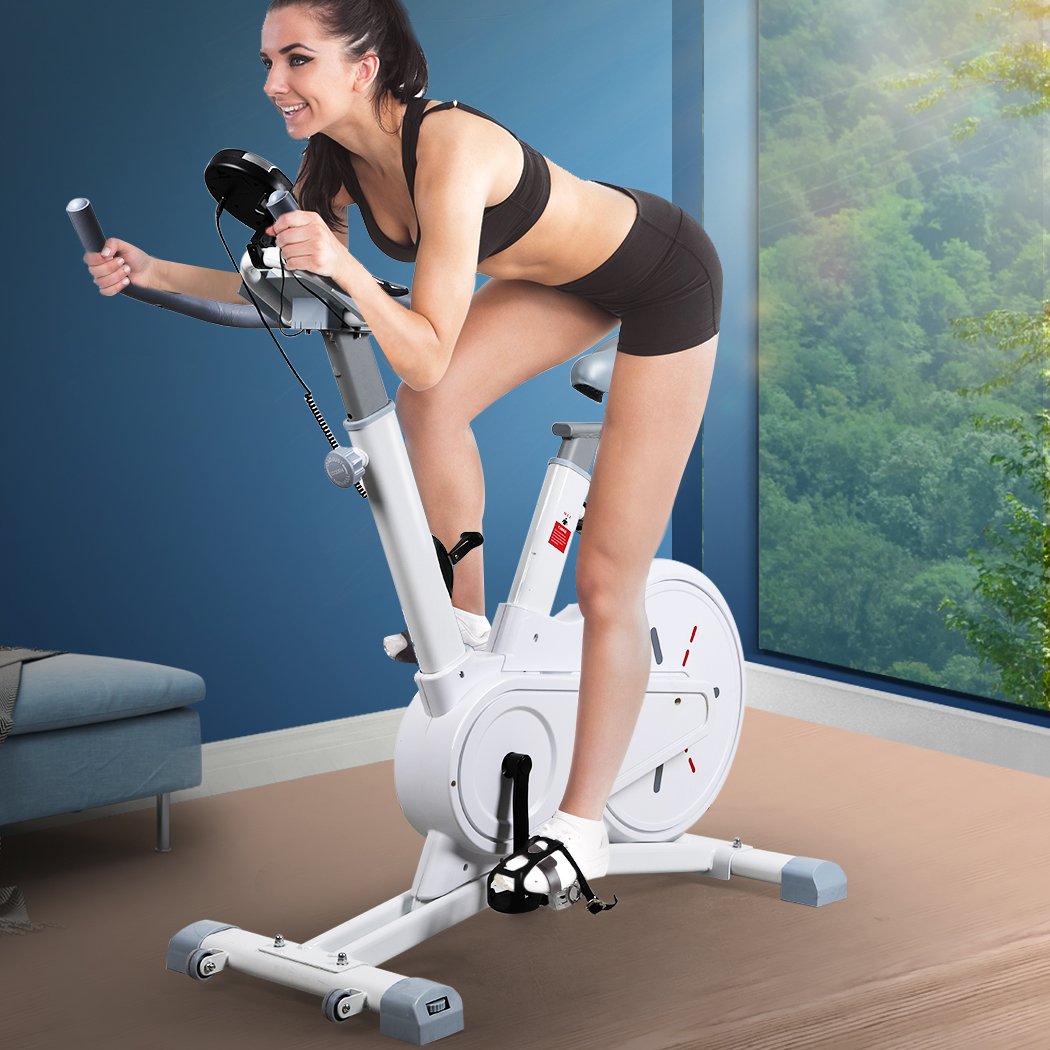 Spin Bike Magnetic Fitness Exercise Bike with adjustable seat and handlebars, digital monitor, and built-in wheels for easy transport.