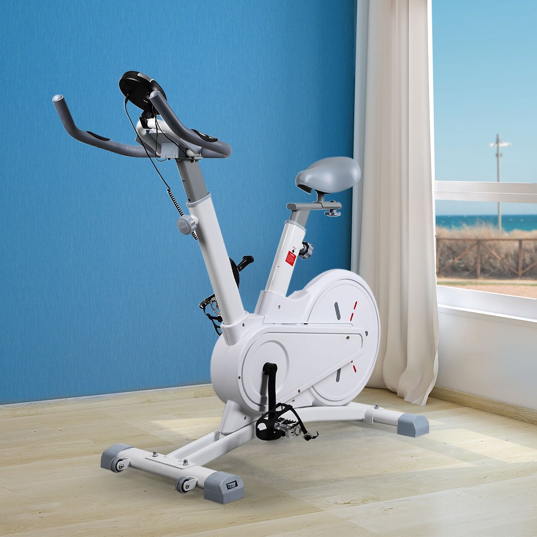 Spin Bike Magnetic Fitness Exercise Bike with adjustable seat and handlebars, digital monitor, and built-in wheels for easy transport.