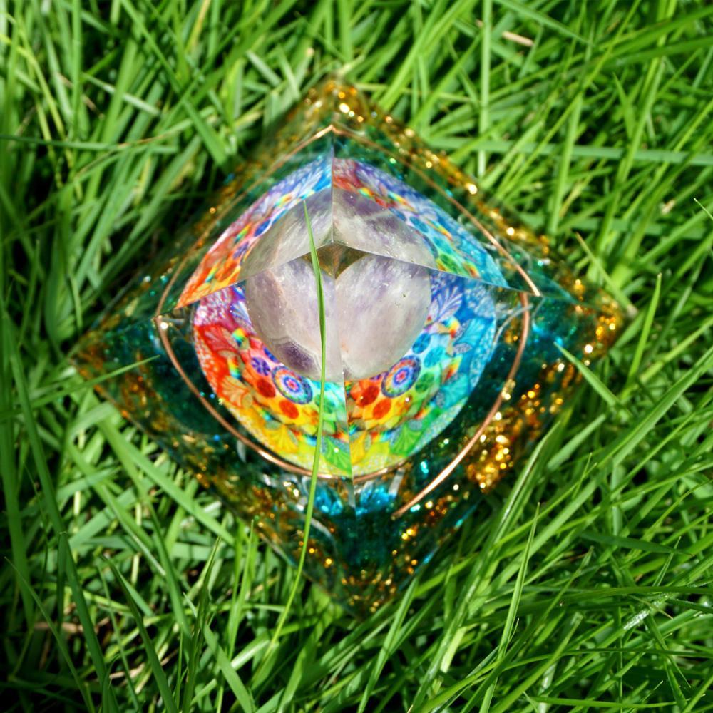 Spiritual Energy Orgone Crystal Pyramid featuring Amethyst crystal, blue cloud, and gold foil patterns.