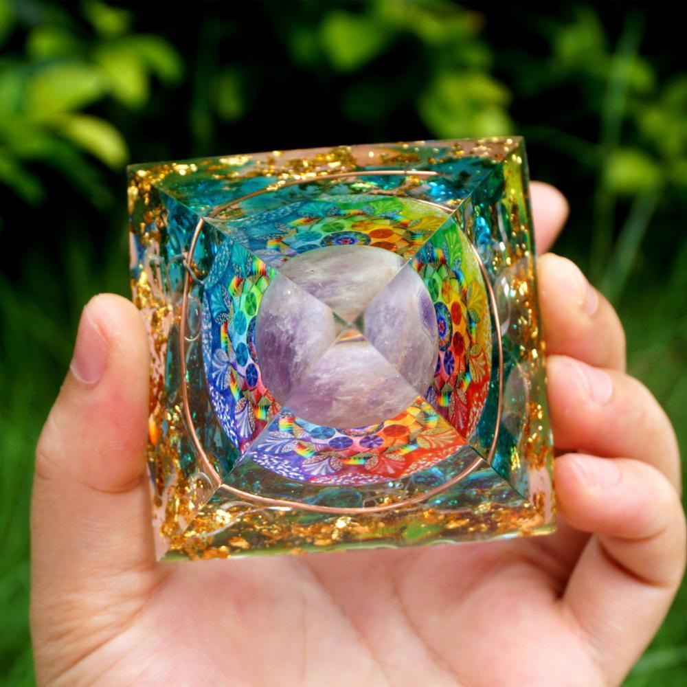 A beautiful Spiritual Energy Orgone Crystal Pyramid featuring an Amethyst crystal at the center, surrounded by a blue cloud and gold foil patterns.