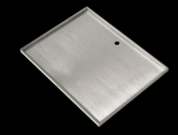 A high-quality stainless steel BBQ hot plate with folded sides and tapered drain hole, perfect for outdoor grilling.